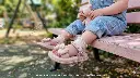 mellow-shoes-baby-pink-party-sandals-6009-outdoor-bench-lifestyle.webp