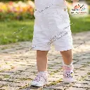 Toddler Girl Walking in Pink Sports Sandals on Stone Path.webp